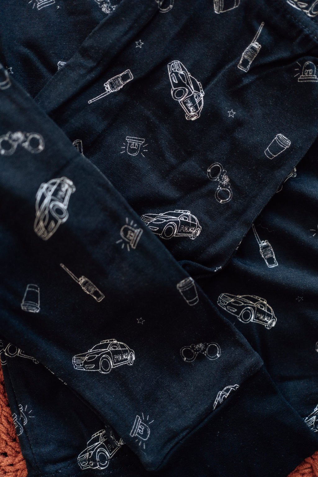 Black toddler pajamas with white police car patterns