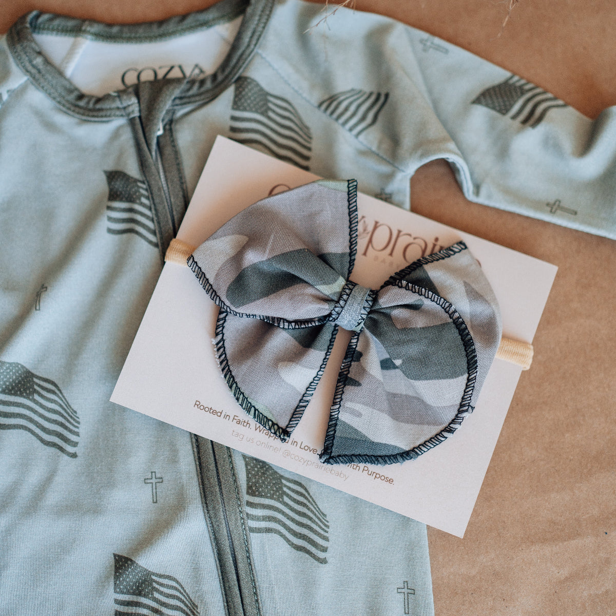 Baby outfit with a bow on a brown surface