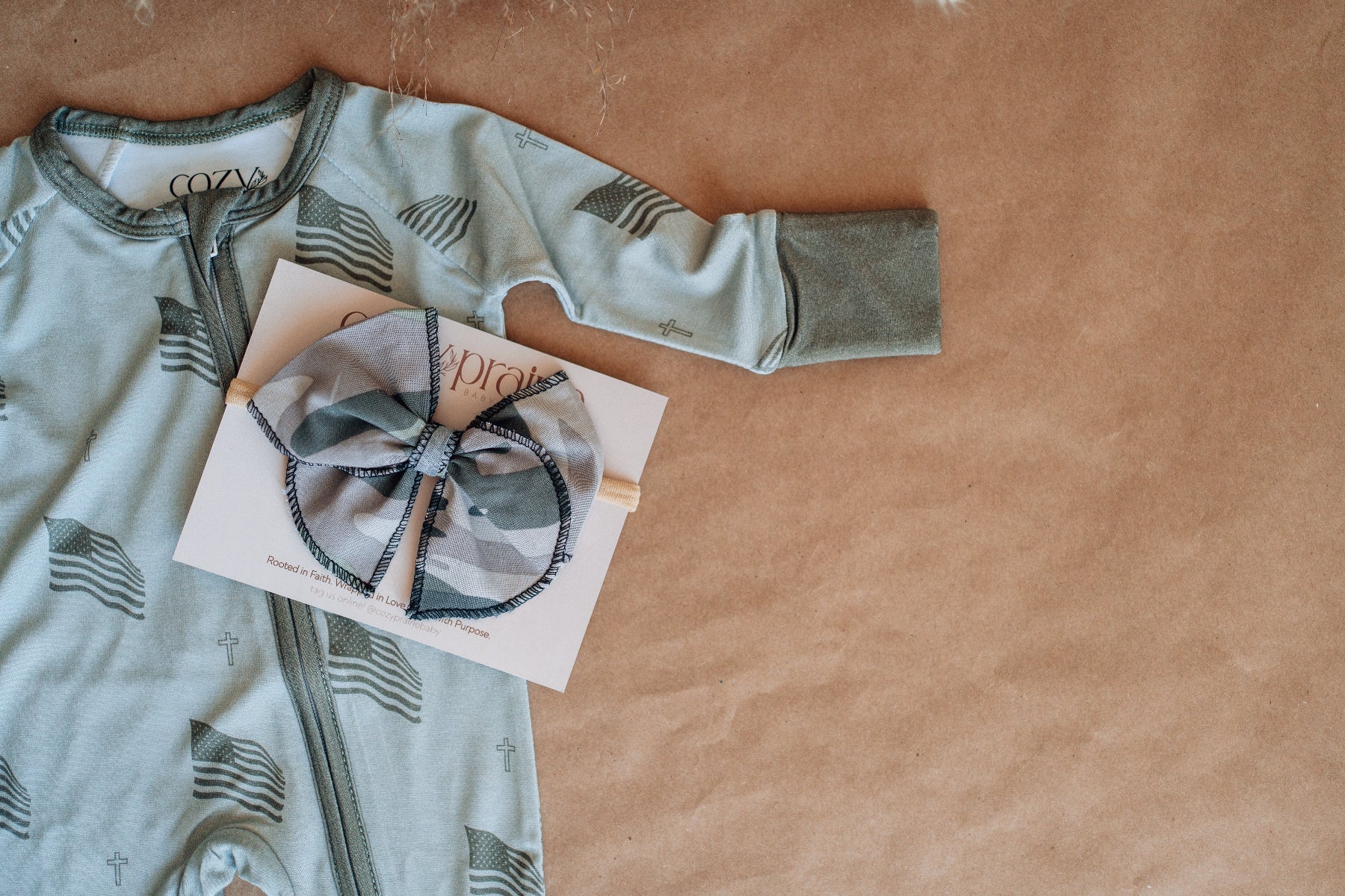 Children's long-sleeve shirt with a bow design on a brown surface