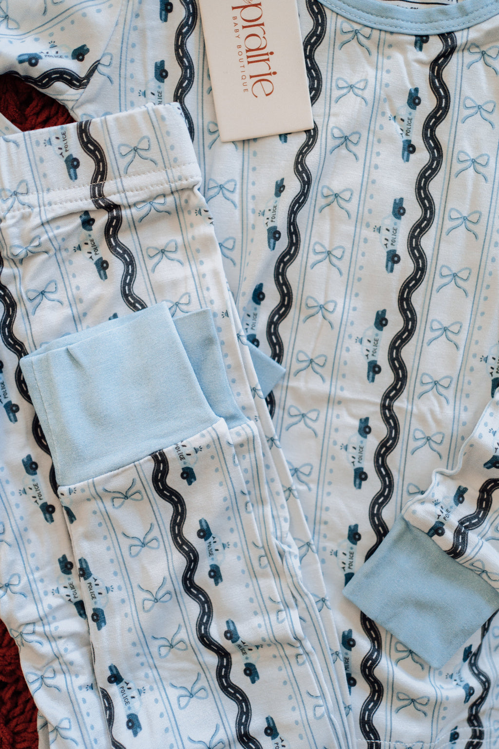 Toddler pajamas with light blue police cars and bows 