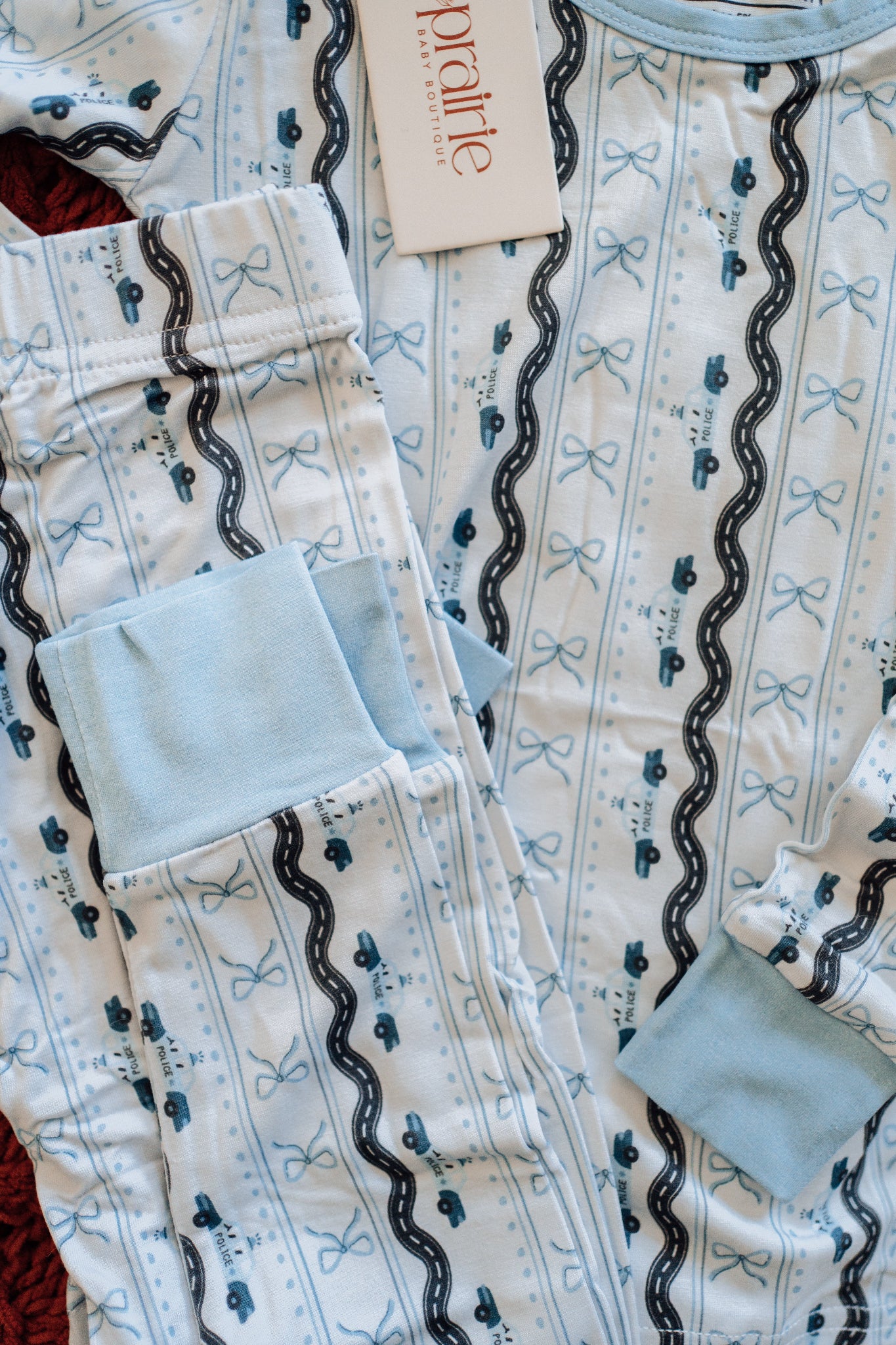 Toddler pajamas with light blue police cars and bows 