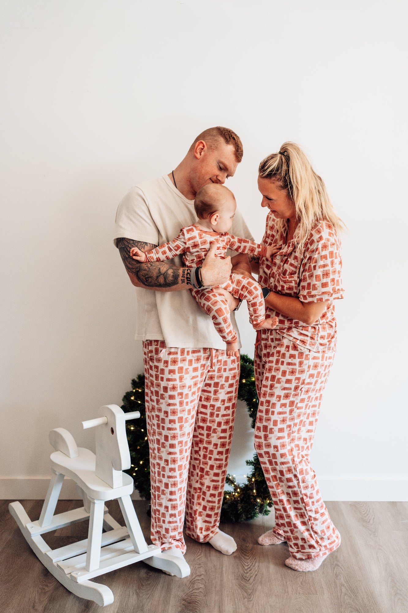 Family of three wearing matching pajamas