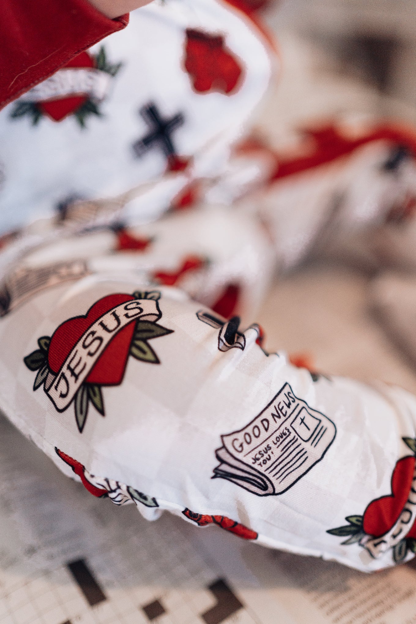 Close-up of a white sleeve with tattoo-like designs on a blurred background